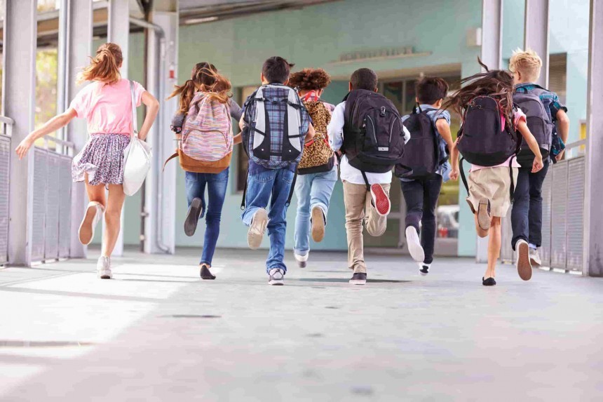 happy kids running into school